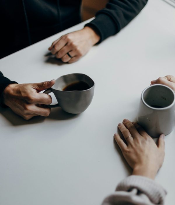 two-people-are-holding-cup-coffee-one-has-spoon-it (1)